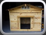 Customized dog house with fan, lamp, carpet, and shingles. House is 4' x 4' x 5'.